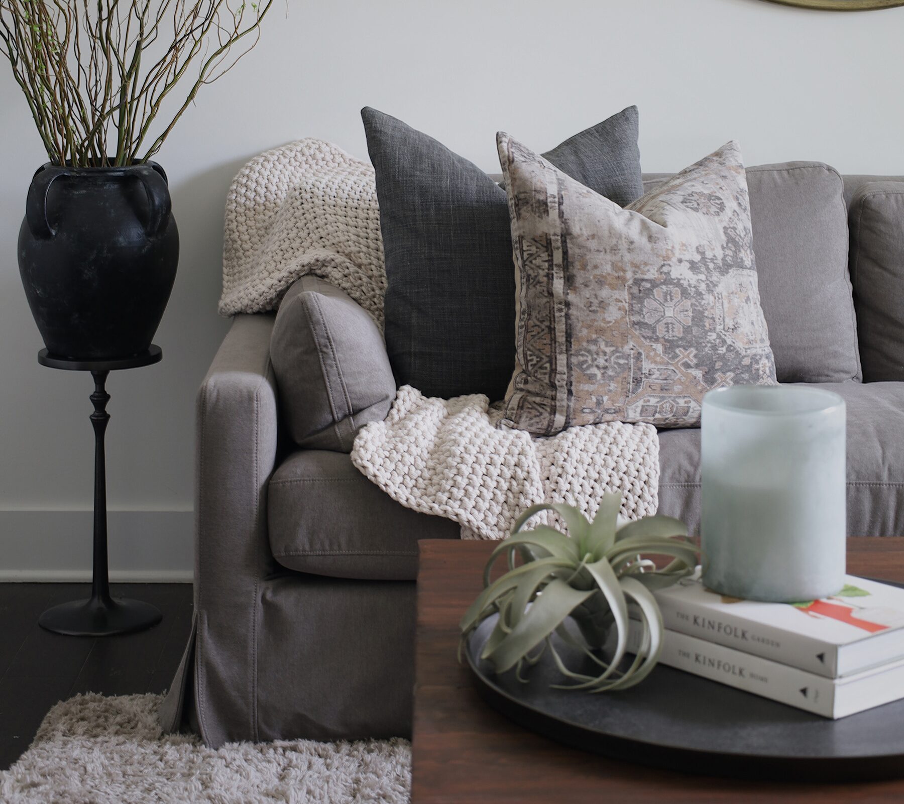 Styled living room photo with textured throw pillows and blankets for the Semimade Home brand
