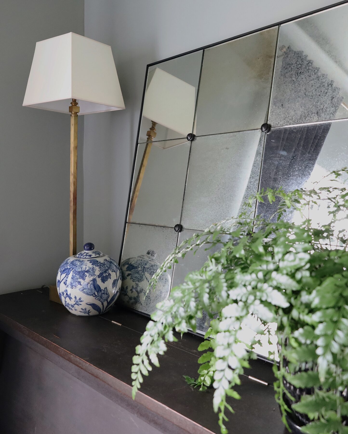 Antiqued mirror and brass floor lamp styled photo for the Semimade Home brand